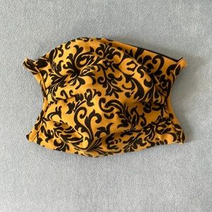 Yellow and black patterned mask by Effie’s Heart with ties.